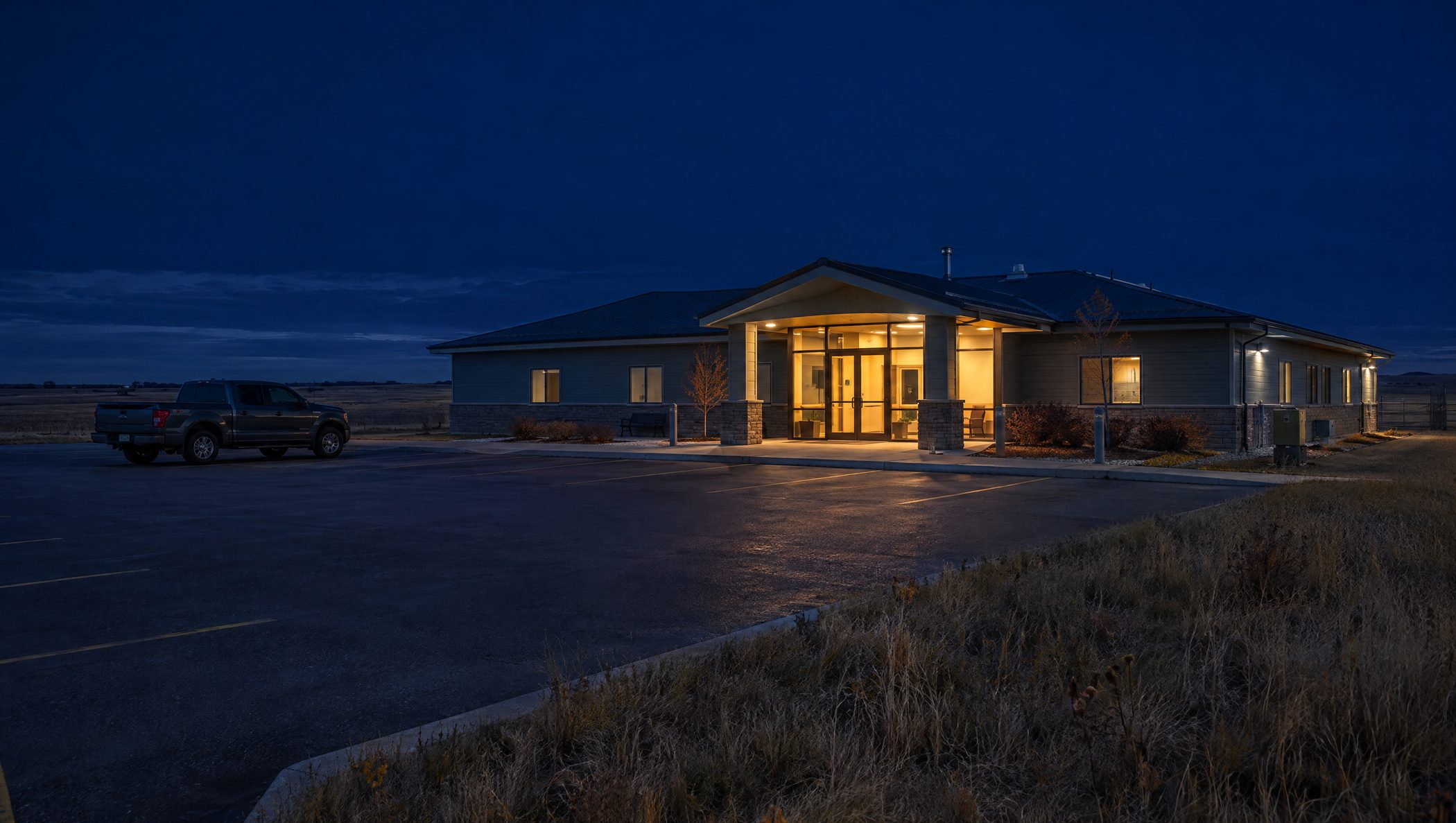 A small rural hospital at night on the prairie